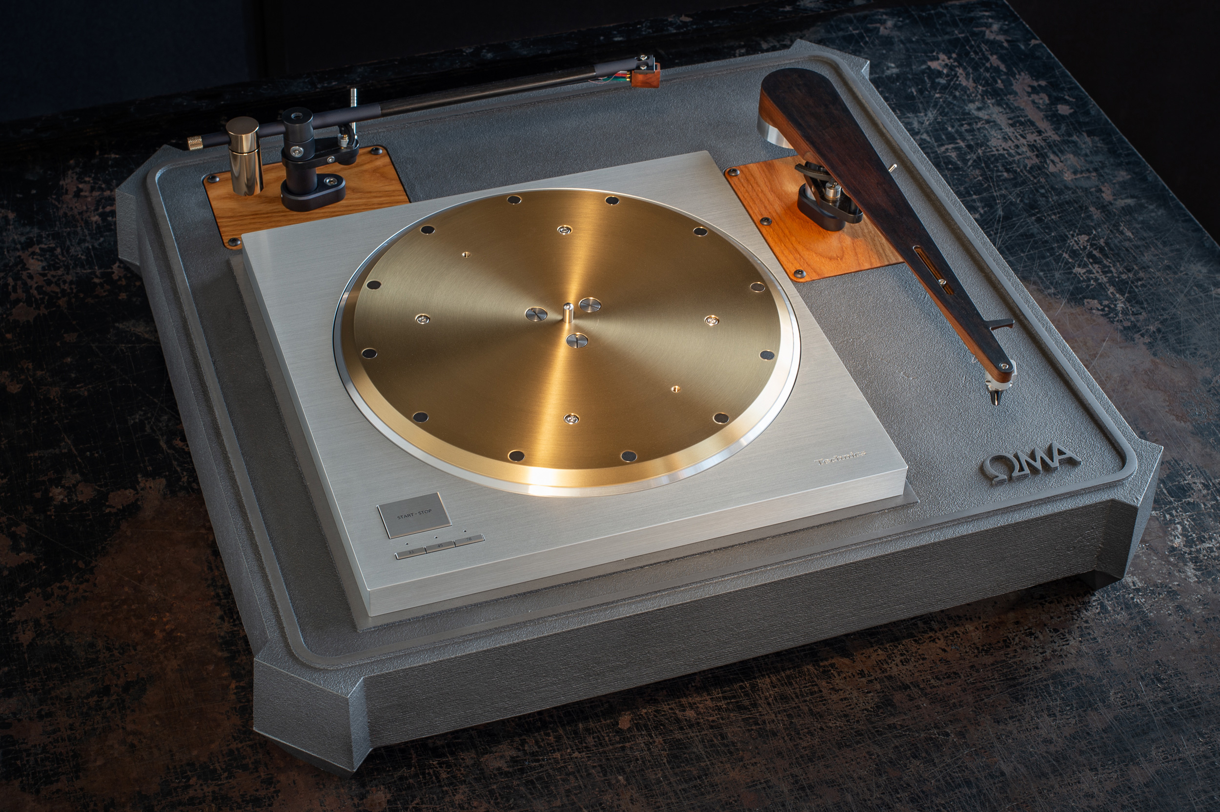 We also offer the OMA SP10R plinth system in a two arm configuration. This substantially increases the size, weight and cost- 23" depth x 25" width x 5" height (top of platter). Shown here with Schroeder CB and Model B tonearms.